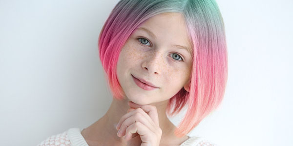 Trendy hairstyle concept. Girl with colorful dyed hair on white